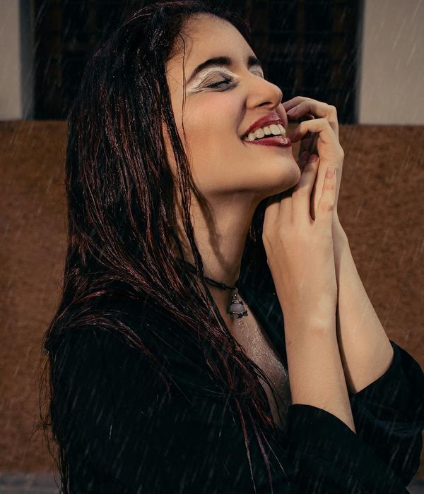 Woman feeling refreshed and calm with her eyes closed.